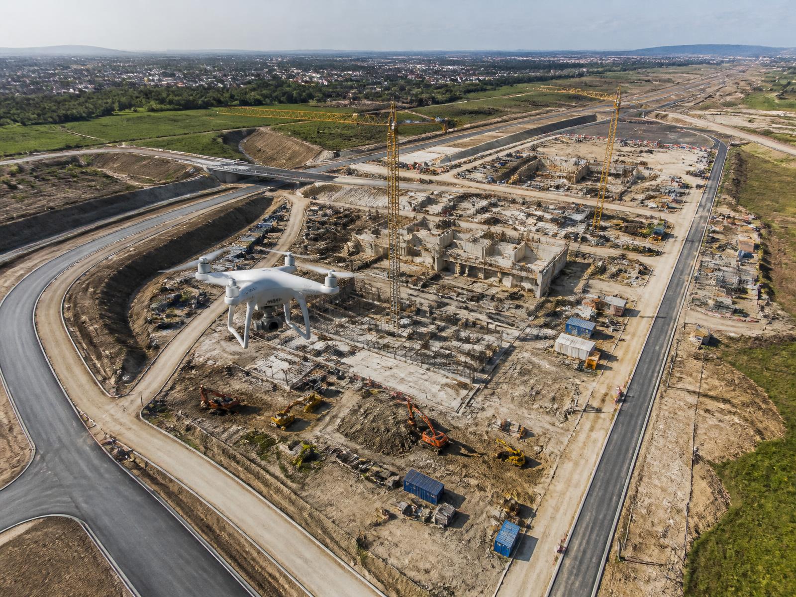 Drone capturing aerial imagery over an infrastructure site
